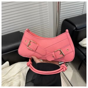 Détail du sac sous le bras rose vif avec boucles en métal et poignée à nœud