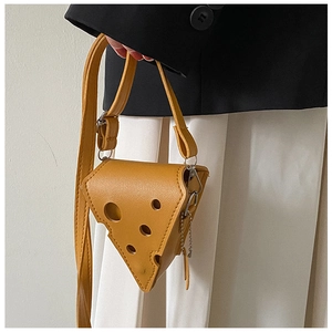 Detail of creative cheese-shaped mini bag with hole texture and metal chain strap