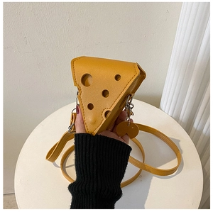 Detail of yellow cheese-shaped mini crossbody bag with Swiss cheese hole patterns