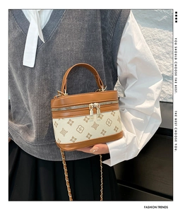 Macro shot of retro monogram print and premium brown leather texture on handbag