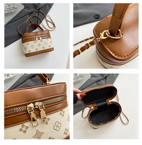 Detail view showing monogram pattern, gold zippers, and interior of a vintage box bag
