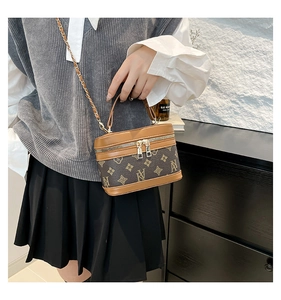 Retro vintage brown pattern box bag shown with chain strap on a fashion model