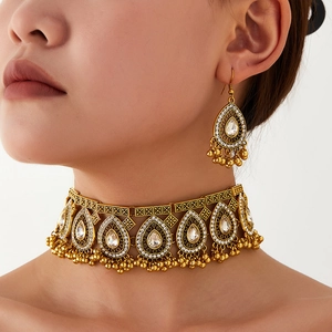 Antique gold jewelry set featuring water drop crystals and bead fringe on a model