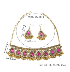 Detailed view of bohemian gold necklace set with pink pear stones and size markings