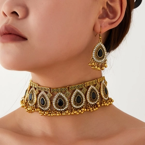 Detail of vintage choker set with black teardrop gems and golden bead fringes