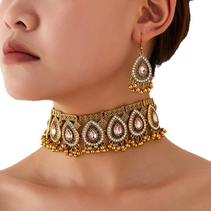 Bohemian vintage jewelry set with pink teardrop gemstones and golden tassels
