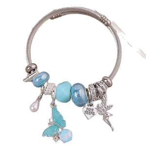 Silver charm bracelet with blue glass beads, butterfly pendant and angel charm on white background