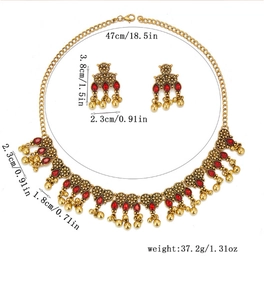 Detail view of vintage jewelry set size specifications with red stones and gold charms