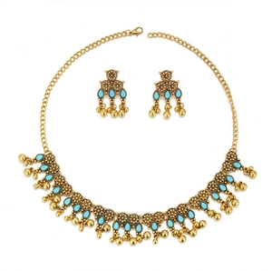 Detail of vintage bohemian jewelry set with blue turquoise stones and metal tassels