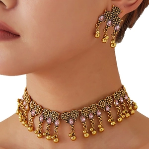 Vintage gold-toned floral jewelry set with pink stones and beaded tassels for women