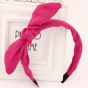 Detail of hot pink rabbit ear headband with soft suede texture and anti-slip tips