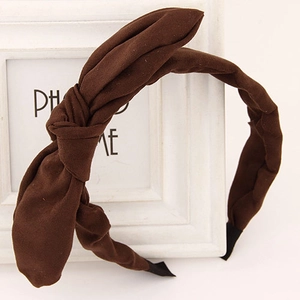 Detail view of dark brown fabric headband featuring a top knot bow and anti-slip tips