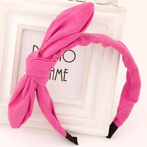 Detail of rose pink bunny ear headband with soft fabric texture and protective end tips