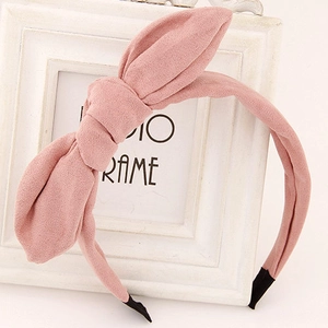 Detailed view of pink bow headband fabric texture and black anti-slip end caps