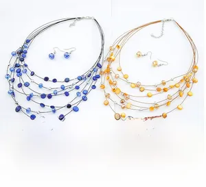 Detail of layered bohemian shell and crystal bead necklaces with matching hook earrings