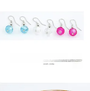 Close-up of bohemian hook earrings featuring faceted beads in blue, pink, and clear colors