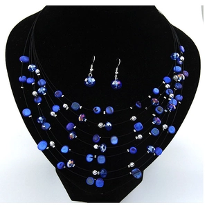 Detail of multi-layer bohemian necklace set with blue crystal beads and matching earrings