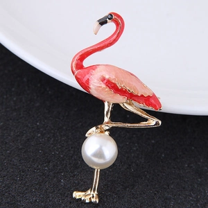 Golden flamingo brooch with red gradient enamel and white pearl detail on porcelain