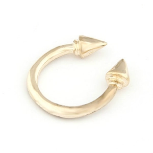Detailed view of golden horseshoe jewelry with sharp spike studs on white background