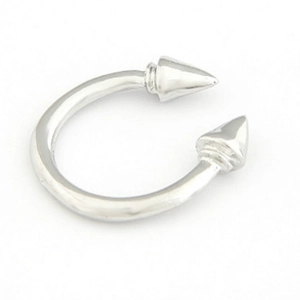 Detailed view of punk style silver U-shaped horseshoe ring with sharp metal spikes