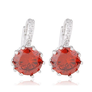Silver drop earrings with large round red zircon and sparkling white accents on white background
