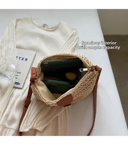 Spacious interior of beige straw crossbody bag showing tablet, phone and wallet storage