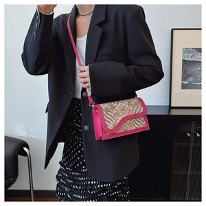 Detail of vintage wave pattern on pink square crossbody bag with gold metal buckle