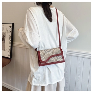 Retro wave pattern crossbody bag shown from behind on a model with white outfit