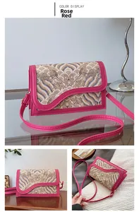 Close-up of rose red crossbody bag with traditional Chinese cloud embroidery patterns