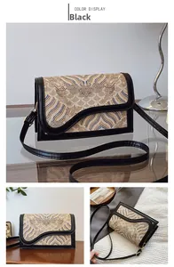 Detail of traditional Chinese wave pattern embroidery on elegant black crossbody bag