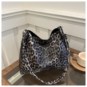 Close-up of leopard print hobo tote bag with a stylish knotted shoulder strap detail