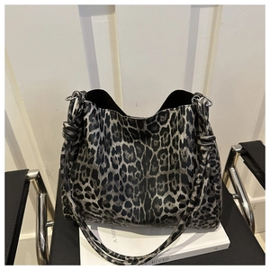 Close-up of leopard print hobo bag featuring knotted handle and silver metal ring detail