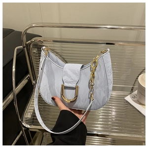 Detail of light blue hobo bag with marble texture and golden D-shaped metal buckle