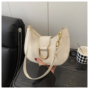 Detail of cream marble-textured underarm bag featuring a gold D-buckle and chain strap