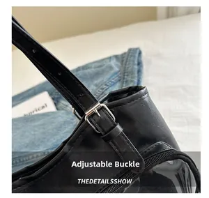 Detail of adjustable shoulder strap with silver metal buckle on black tote bag