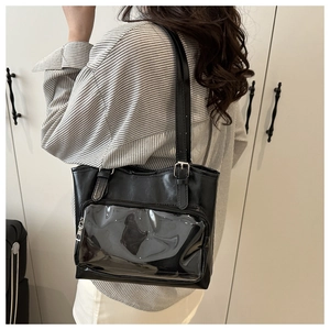 Close-up of black PU leather tote bag with transparent PVC pocket for badge display