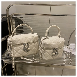 Vue détaillée de l'ensemble de sacs seaux crème avec chaîne et détails métalliques
