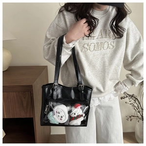 Detailed view of black Ita Bag with clear PVC window and adjustable leather strap