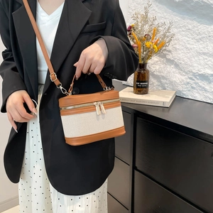 Vintage contrast canvas and brown leather box bag shown with a stylish shoulder strap