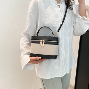 Chic monochrome box-shaped crossbody bag with woven canvas and black leather accents
