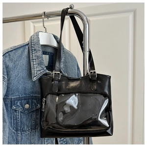 Detail of black PU leather ita bag with a large clear PVC window and silver zipper