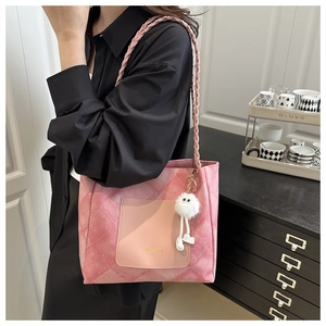 Detail of pink tie-dye tote bag with FASHION pocket and white fuzzy monster charm