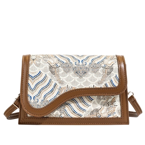 Ethnic embroidery crossbody bag with brown leather trim and traditional cloud patterns