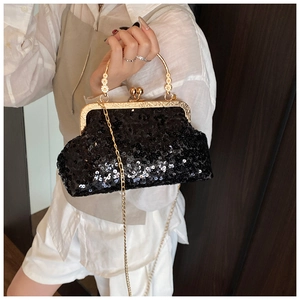 Detail of vintage black sequin evening bag with gold floral handle and chain strap