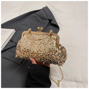 Macro view of glittering gold sequin evening clutch with vintage metal clasp and handle