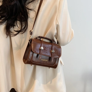 Vintage dark brown faux leather crossbody bag with top handle and gold fashion lettering