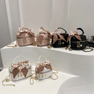 Quilted mini bucket bags in white, pink, and black with leopard bow and chain straps