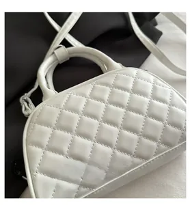Detailed close-up of white quilted leather bag showing fine stitching and craftsmanship