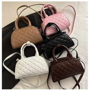 Detailed top view of quilted bowling bags in five colors with handles and straps