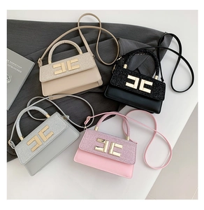 Detail showing high-end small square handbags in four colors with gold metal logo buckles